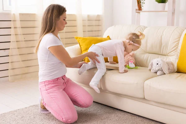 Happy child girl with cochlear implant having fun with her mother - hearing aid for deaf and innovative health technology and diversity concept
