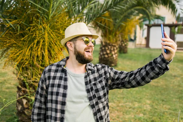 Man Taking Selfie Portrait Palm Tree Background Happy Millennial Guy — Stok fotoğraf