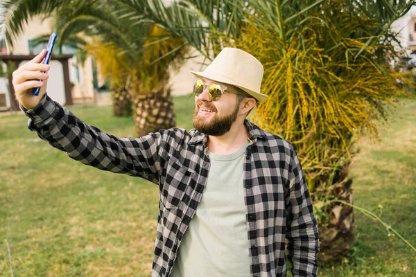 Man Taking Selfie Portrait Palm Tree Background Happy Millennial Guy — Stok fotoğraf