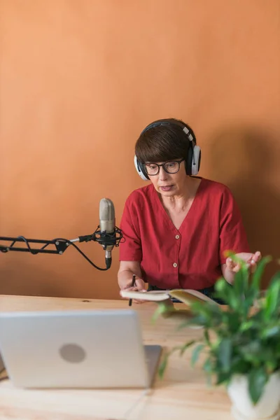 Portrait Mature Woman Wearing Headphones Talking Online Radio Station Podcast — Foto de Stock