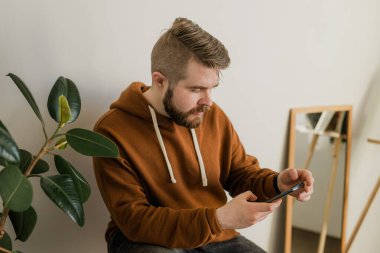Cep telefonu kullanan serbest çalışan, sosyal medya ağını kontrol eden ya da evdeki yatakta oturup mesajlaşan biri. Sıkı çalışma gününden sonra çevrimiçi dijital iletişim dinlenme
