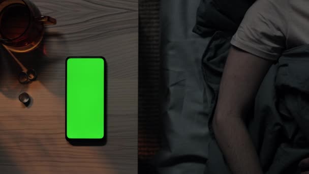 Green screen mobile lying on table while woman sleeping — Stock Video
