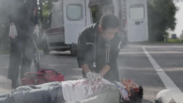 Team av EMS Paramedics försöker hjälpa bilolycka offer — Stockvideo