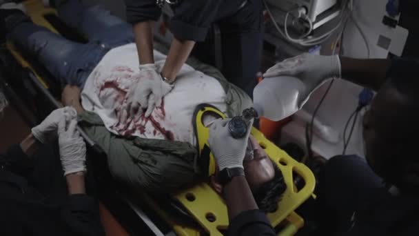 Multicultural paramedics rescuing man in ambulance car