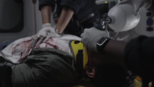 Team av ambulanspersonal som gör hjärtmassage för patienten — Stockvideo