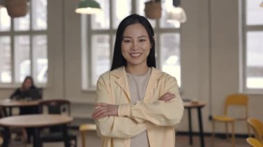 Sıcak kafeteryada duran gülümseyen Asyalı kadının portresi