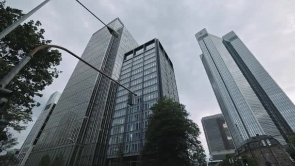 FRANKFURT - 5. Juli 2021: Langsam steigt die Drohne über Frankfurt am Main auf. Neuer Wolkenkratzer am bewölkten Tag mit leeren Straßen in der Stadt. Drohnenschuss. — Stockvideo