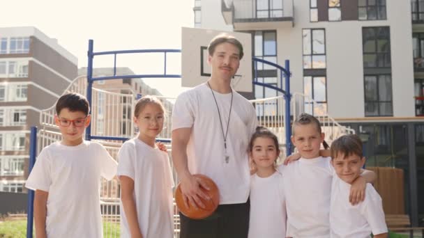 Portrait Proud Primary School Basketball Coach His Young Team Outdoor — ストック動画