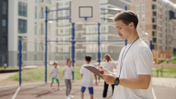School Coach Writting Notes Basketball Game Trainer Standing Basketball Court — Stockvideo