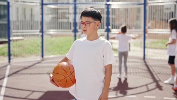 Portrait Little Asian Boy Glasses Standing Ball Outdoors School Basketball — ストック動画