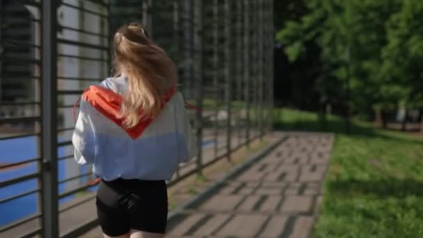 Back View Woman Running Sportfield Listening Music While Running Runner — Stockvideo