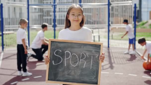 Portrait Asian Girl Standing Basketball Court Schoolboard Hands Text Sport — Wideo stockowe