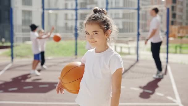 School Girl Standing Basketball Court Turn Looking Camera Holding Ball — Vídeos de Stock