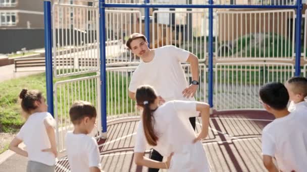 Male Coach Primary School Children Warm Workout Outdoor Group Elementary — Αρχείο Βίντεο