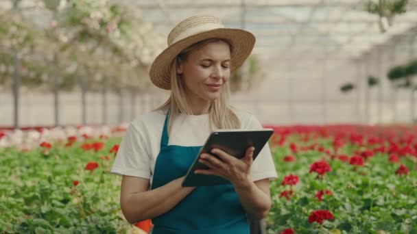 Portrait Female Smiling Gardener Wearing Hat Holding Tablet Standing Shelf — Video Stock