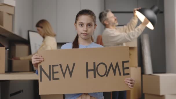 Portrait Smiling Little Daughter Holding Sign Poster New Home Looking — Stockvideo