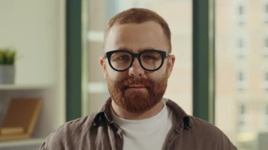 Portrait of the handsome happy smiled male teacher wearing casual clothes standing looking at the camera in a class background. People and educational concept
