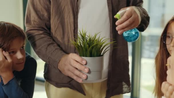 Close View Male Teacher Hands Spraying Plant Showing Pupils Teacher — 图库视频影像