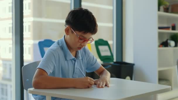 Asian Pupil Wearing Glasses Sits Desk School Fills Out Tests — Stockvideo