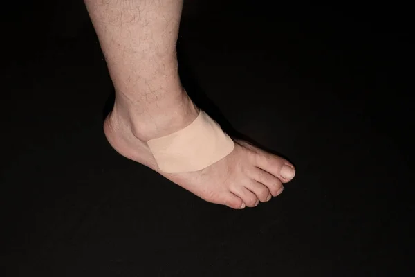 Adhesive Healing plaster on asian man foot for first aid concept