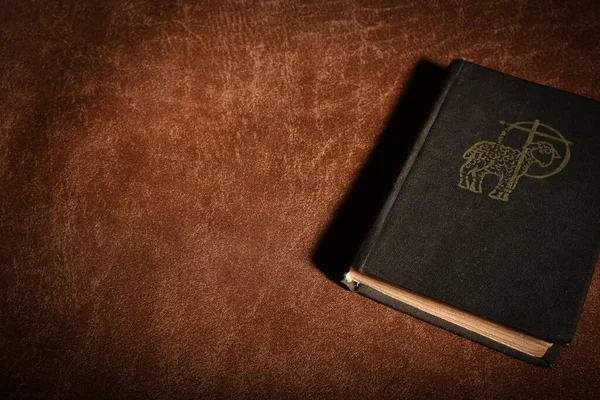 The Book of Pray. Ancient Prayer Book with Lamb of God Symbol on Cover.