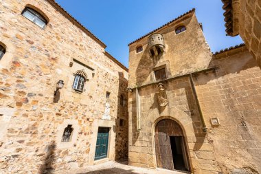 Caceres, Spain. April 29, 2022. Picturesque corner of the historic center of the city. On the right side the House of the Sun and on the left the House of the Eagle