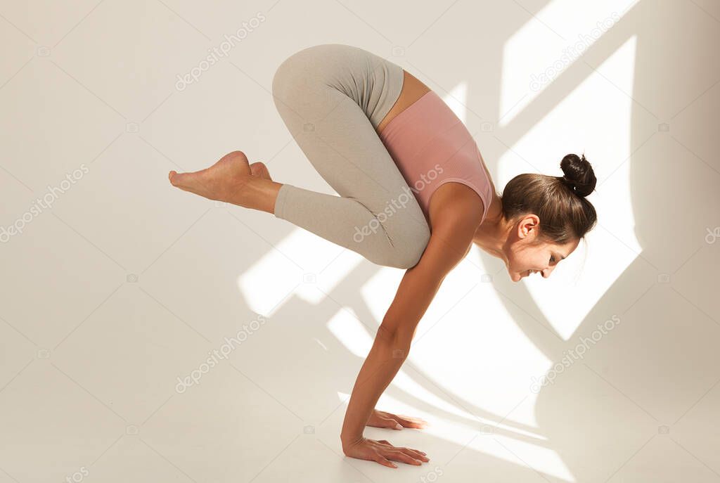 yoga and gymnastics, young girl doing yoga, bakasan crane pose