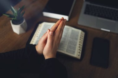 Woman praying by faith with computer laptop, Church services online concept, Online church at home concept, spirituality and religion.
