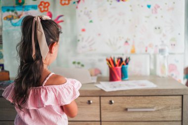 Little girl drawing with color pen in paper on table at playroom, Baby healthy and preschool concept.
