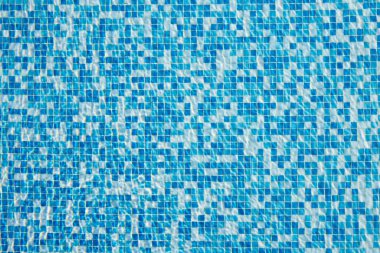 Abstract background of sparkling cool blue water in a mosaic swimming pool