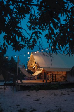 Glamping tent in the forest. Luxury tent sea view. Nature green tourism.