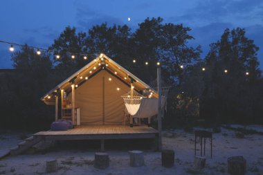 Glamping tent in the forest. Luxury tent sea view. Nature green tourism.