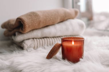 Candle on the windowsill. Autumn mood.