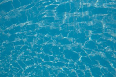 Abstract background of sparkling cool blue water in a swimming pool