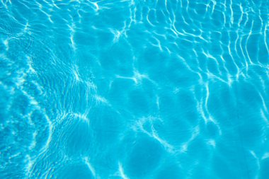 Abstract background of sparkling cool blue water in a swimming pool