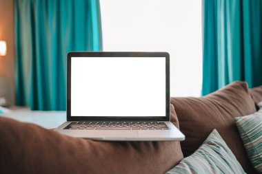 Mock up Blank screen laptop on the bed for advertising and text.