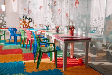 Chairs, table and toys. Interior of kindergarten. Kids play room.