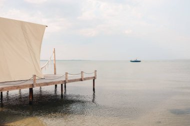 Glamping tent in the forest. Luxury tent sea view. Nature green tourism.