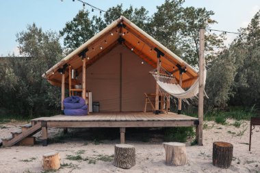Glamping tent in the forest. Luxury tent sea view. Nature green tourism.