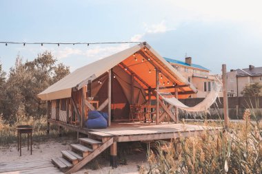 Glamping tent in the forest. Luxury tent sea view. Nature green tourism.