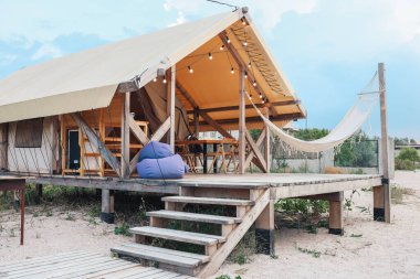 Glamping tent in the forest. Luxury tent sea view. Nature green tourism.
