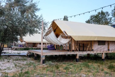 Glamping tent in the forest. Luxury tent sea view. Nature green tourism.