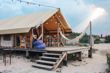 Glamping tent in the forest. Luxury tent sea view. Nature green tourism.