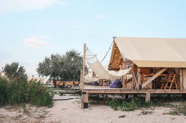 Glamping tent in the forest. Luxury tent sea view. Nature green tourism.