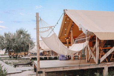 Glamping tent in the forest. Luxury tent sea view. Nature green tourism.