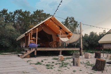 Glamping tent in the forest. Luxury tent sea view. Nature green tourism.