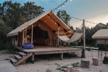 Glamping tent in the forest. Luxury tent sea view. Nature green tourism.