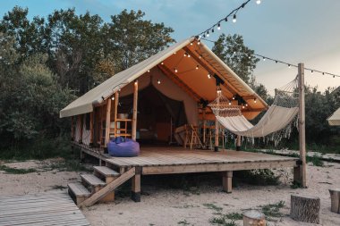 Glamping tent in the forest. Luxury tent sea view. Nature green tourism.