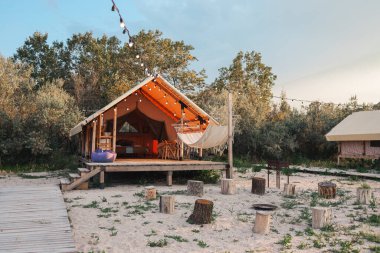 Glamping tent in the forest. Luxury tent sea view. Nature green tourism.