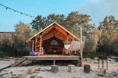 Glamping tent in the forest. Luxury tent sea view. Nature green tourism.